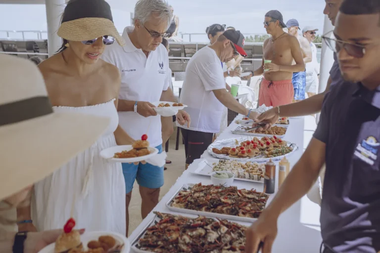 Guests plating food from the buffet at a corporate event