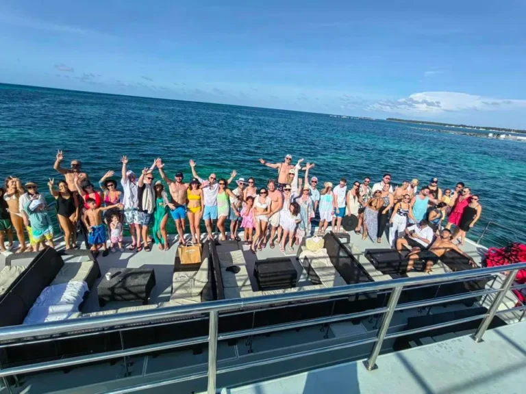 A corporate group on the upper deck of an event catamaran
