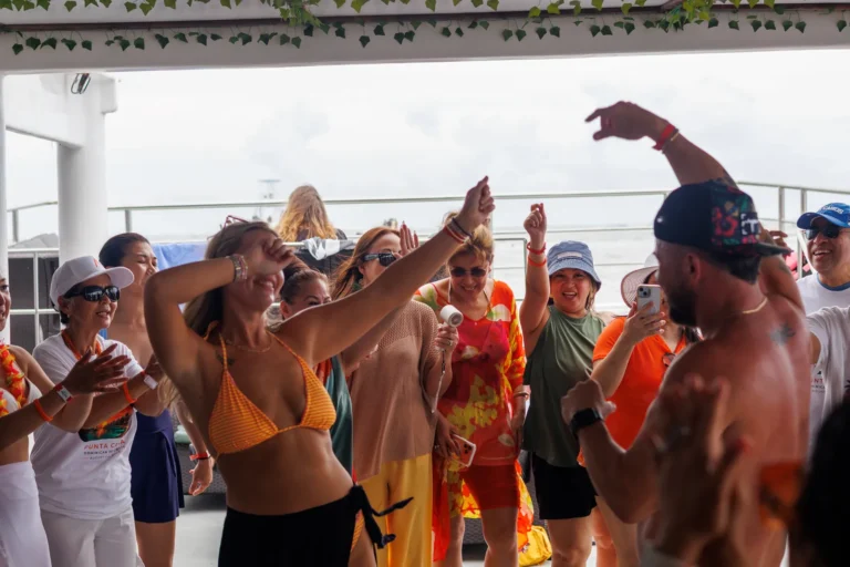 A group dancing on the covered deck of a Hispaniola charter