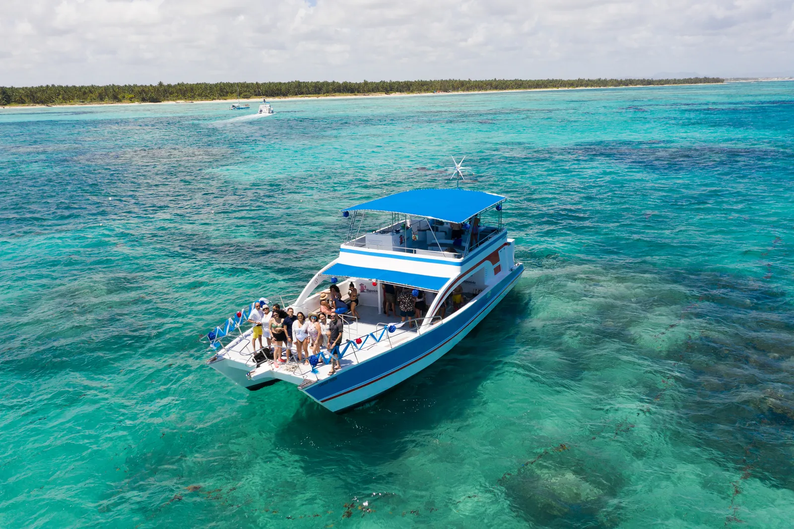 A private catamaran anchored in turquoise water off Punta Cana