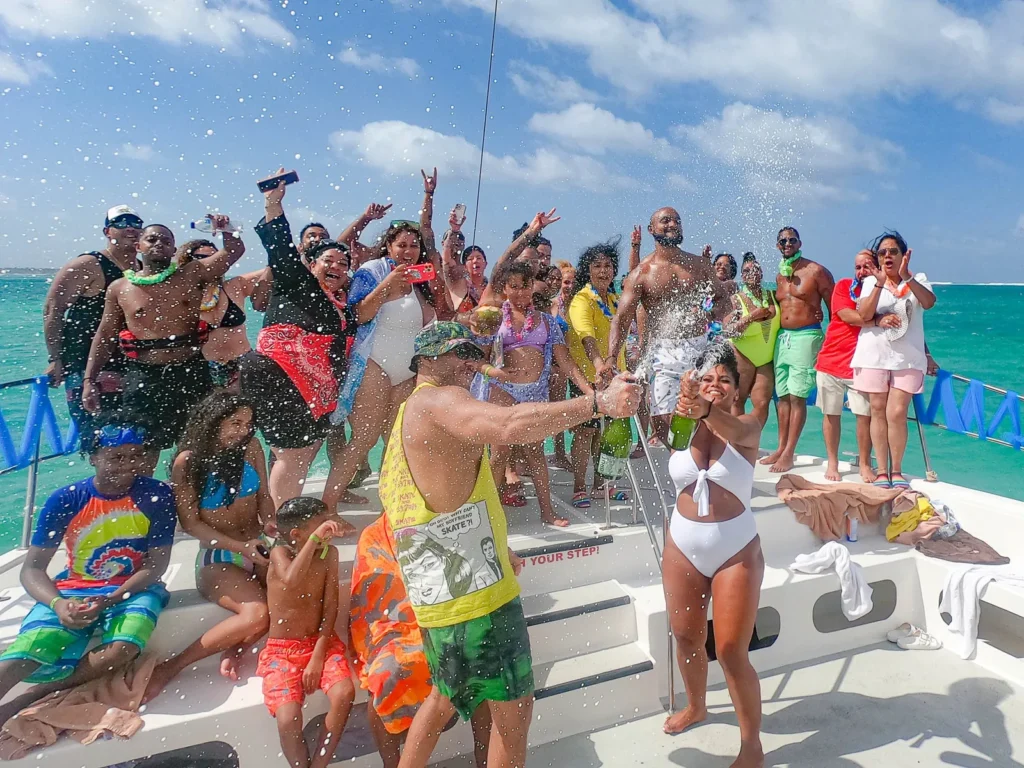 A group celebrating with champagne on the deck of a private party boat in Punta Cana