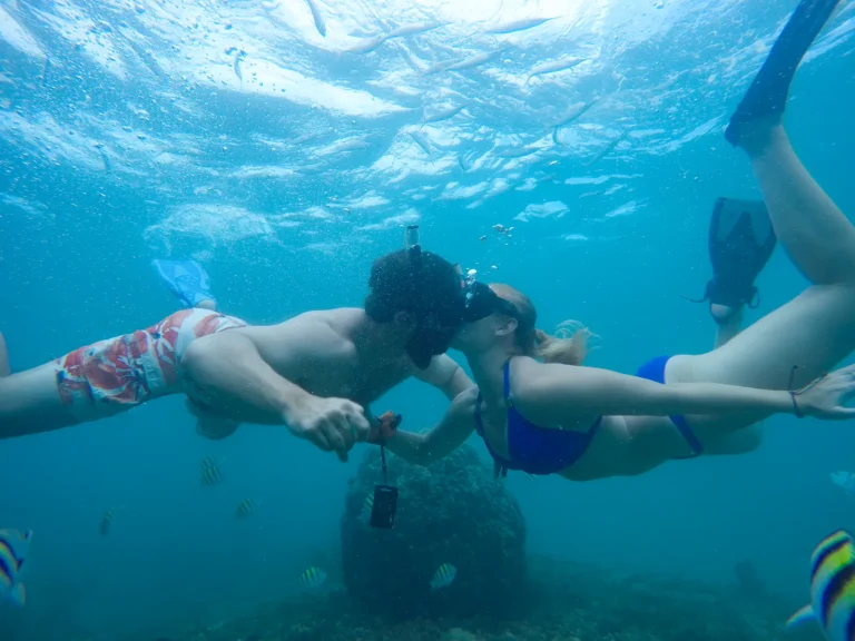 A couple snorkelling hand in hand