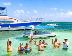 The catamaran anchored in shallow turquoise water