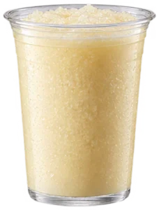 A frozen Piña Colada served in a clear cup on board