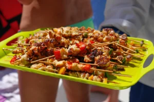 A tray of grilled skewers handed round on deck
