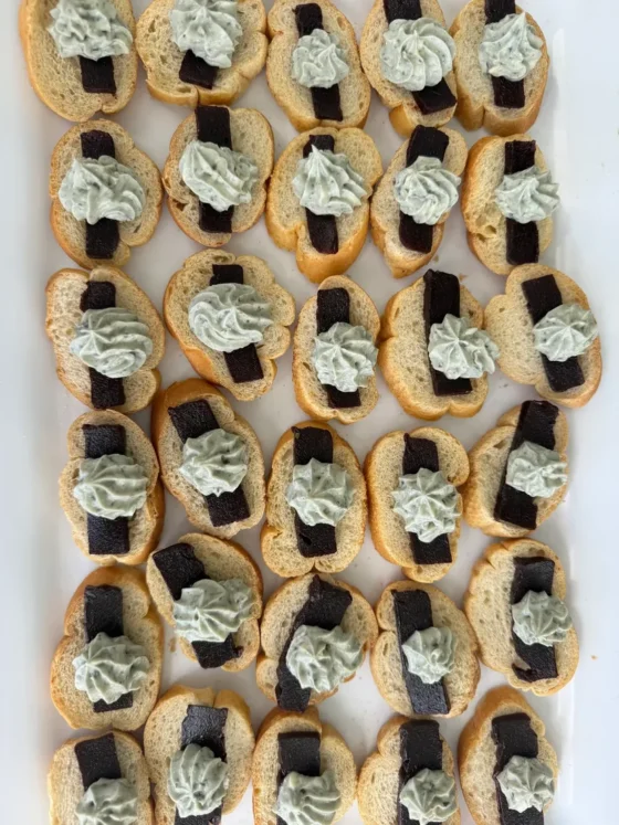 A tray of cream-topped canapes seen from above