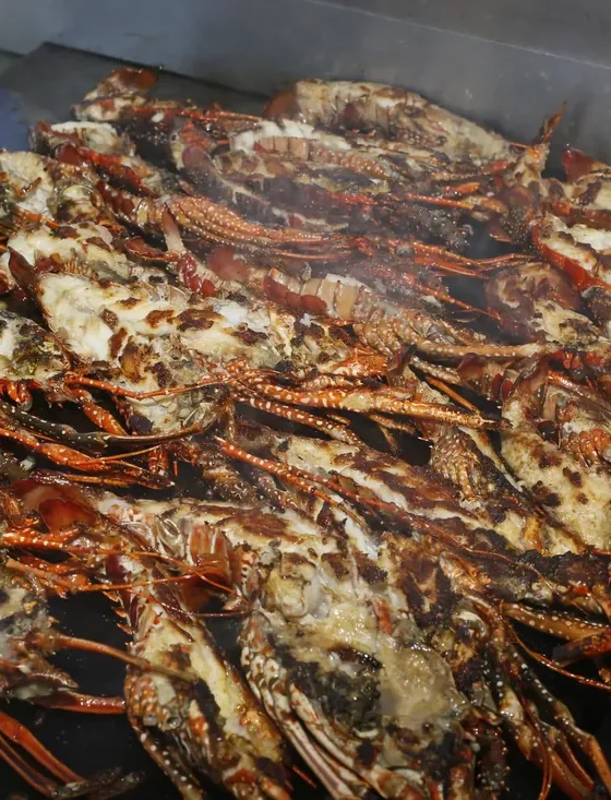 Lobsters cooking on the grill of the floating kitchen