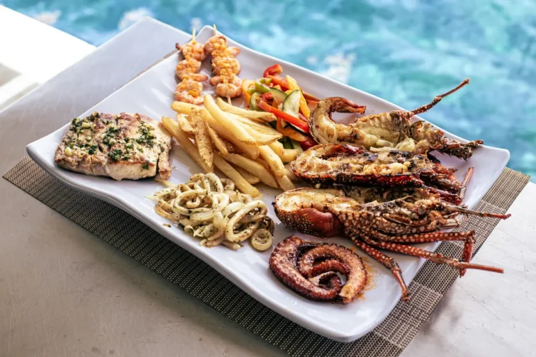 A plated grill of lobster, octopus, fish and fries served on board