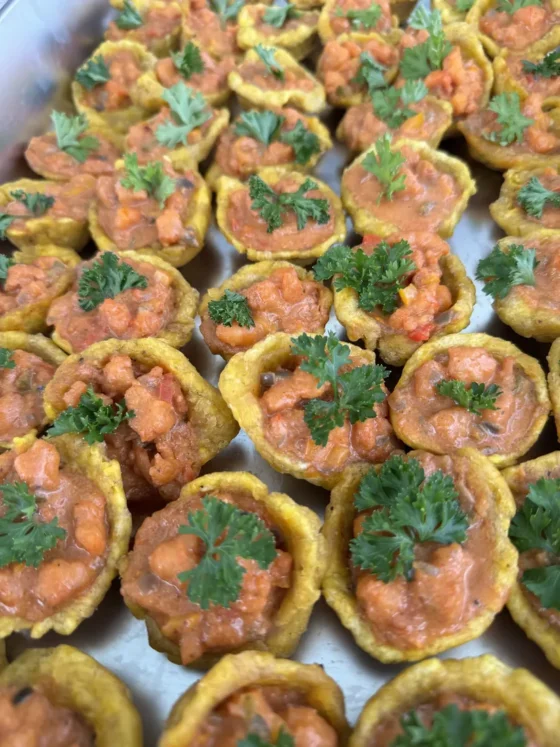 Savory tartlets topped with herbs, passed round on deck